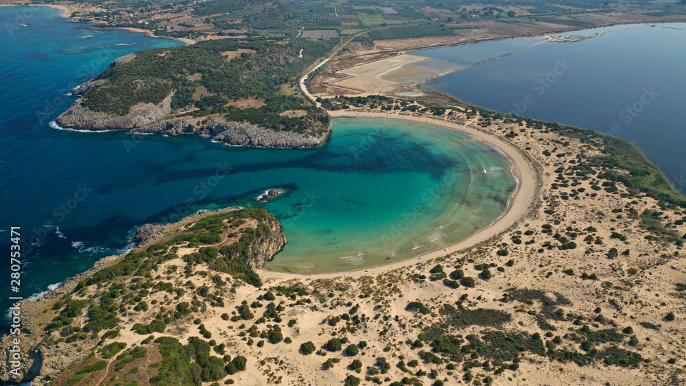 Naklejka premium Aerial drone view of semicircular sandy beach and lagoon of Voidokilia, one of the most iconic beaches in Mediterranean sea, with crystal clear turquoise sea, Messinia, Greece