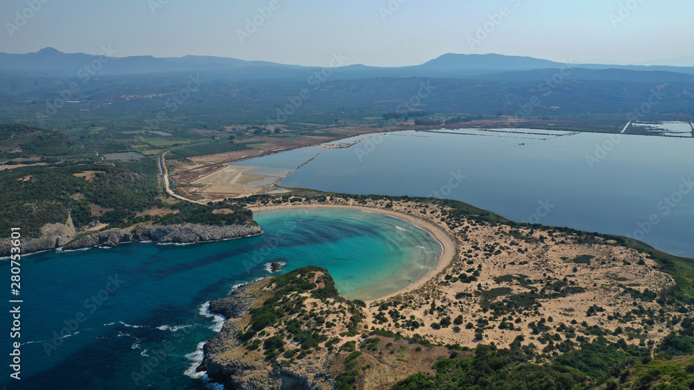 Fototapeta premium Aerial drone view of semicircular sandy beach and lagoon of Voidokilia, one of the most iconic beaches in Mediterranean sea, with crystal clear turquoise sea, Messinia, Greece