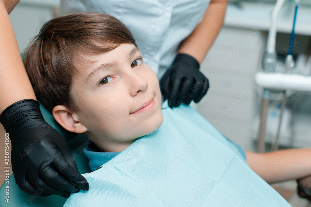 Patient in dental chair. Little boy having dental treatment at dentist's office. Healthy teeth, dental care concept. Patient in dental chair. Little boy having dental treatment at dentist's office. Healthy teeth, dental care concept.