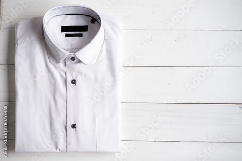 white shrit on the wooden background. photo