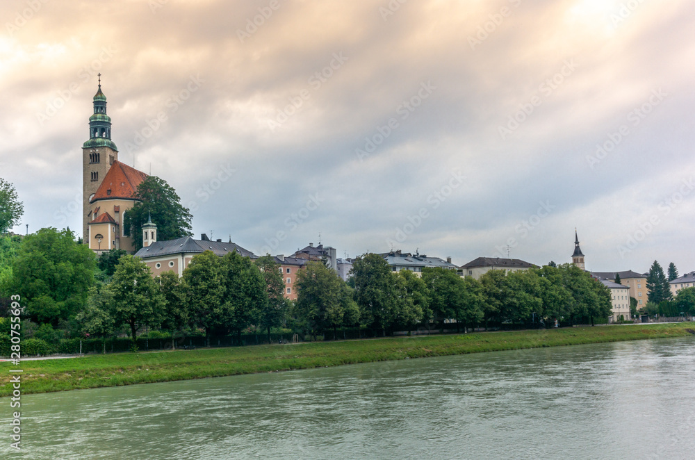 The Salzach river flowing in Salzburg in Austria and its riverside