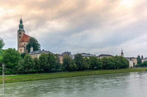 The Salzach river flowing in Salzburg in Austria and its riverside © gdefilip