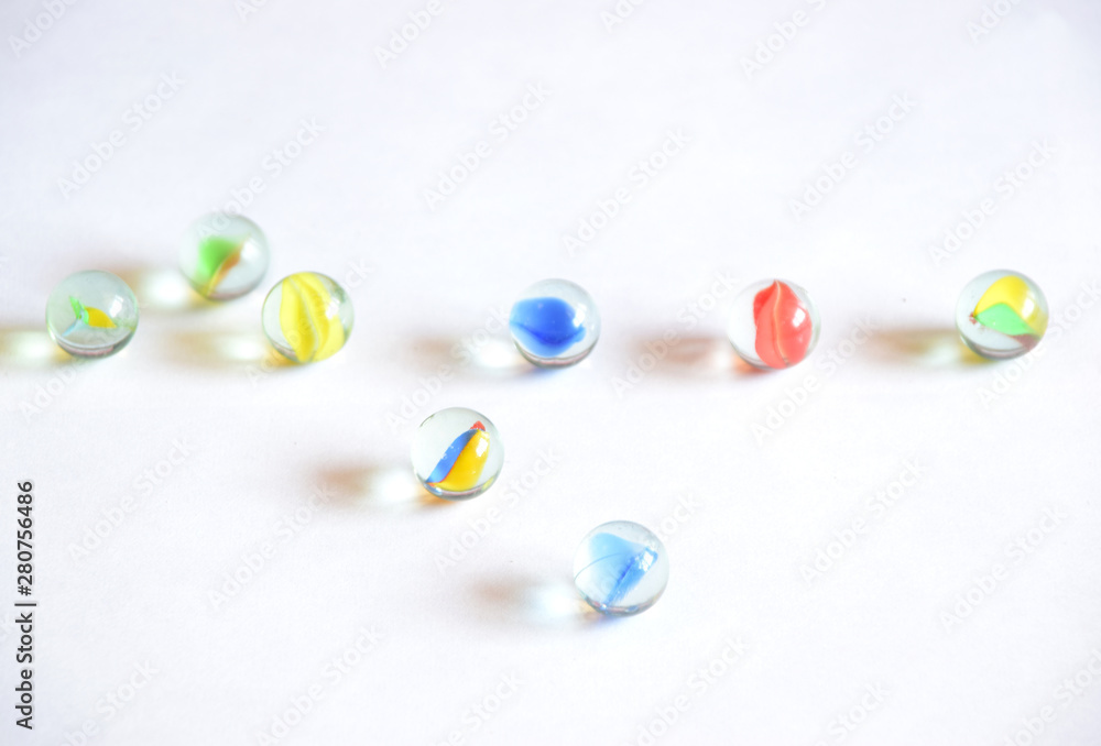Fototapeta premium Colorful round glass balls in white background