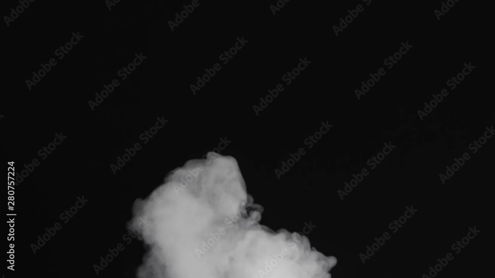 Slow motion of water vapor cloud comes from below over black background Slow motion of water vapor cloud comes from below over black background