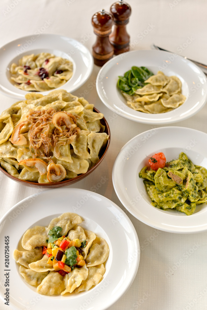 many different vareniki in plates on the table many different vareniki in plates on the table
