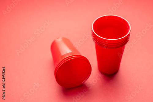Many Red plastic glasses on a red background