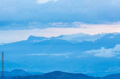 Andean mountain range with mist during dusk hours. 
