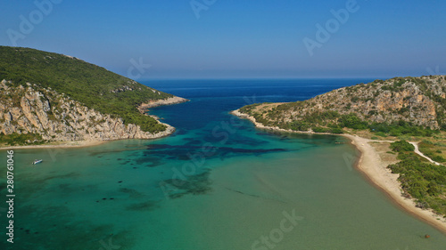 Aerial drone photo of iconic secluded sandy beach with emerald sea in island of Sfaktiria next to bay and famous beach of Divari  chrysi akti   Messinia  Gialova  Peloponnese  Greece