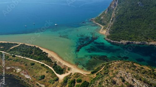 Aerial drone photo of iconic secluded sandy beach with emerald sea in island of Sfaktiria next to bay and famous beach of Divari (chrysi akti), Messinia, Gialova, Peloponnese, Greece photo