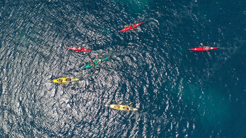 Aerial drone photo of colourful sport canoes operated by young athletes competing in Mediterranean bay with crystal clear turquoise sea