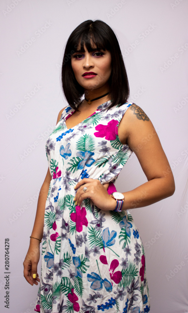 Tanned short-haired girl in flowered dress having fun Tanned short-haired girl in flowered dress having fun