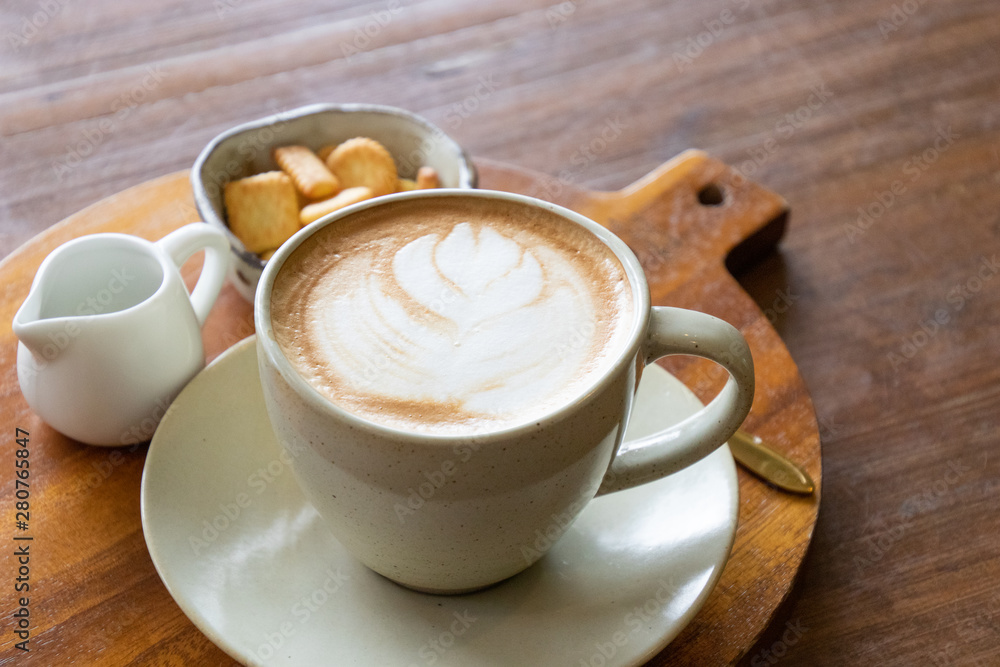 Coffee cup latte art with cookie and fresh milk breakfast set menu on wooden table Coffee cup latte art with cookie and fresh milk breakfast set menu on wooden table