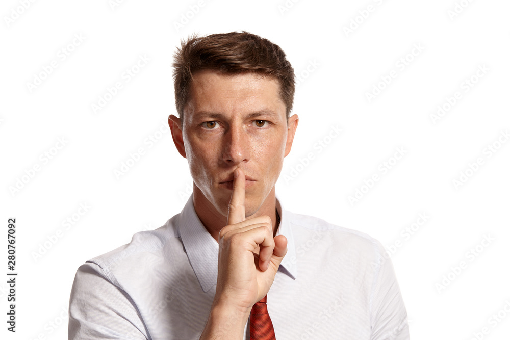 Portrait of a young brunet man posing in a studio isolated over a white background. Portrait of a young brunet man posing in a studio isolated over a white background.