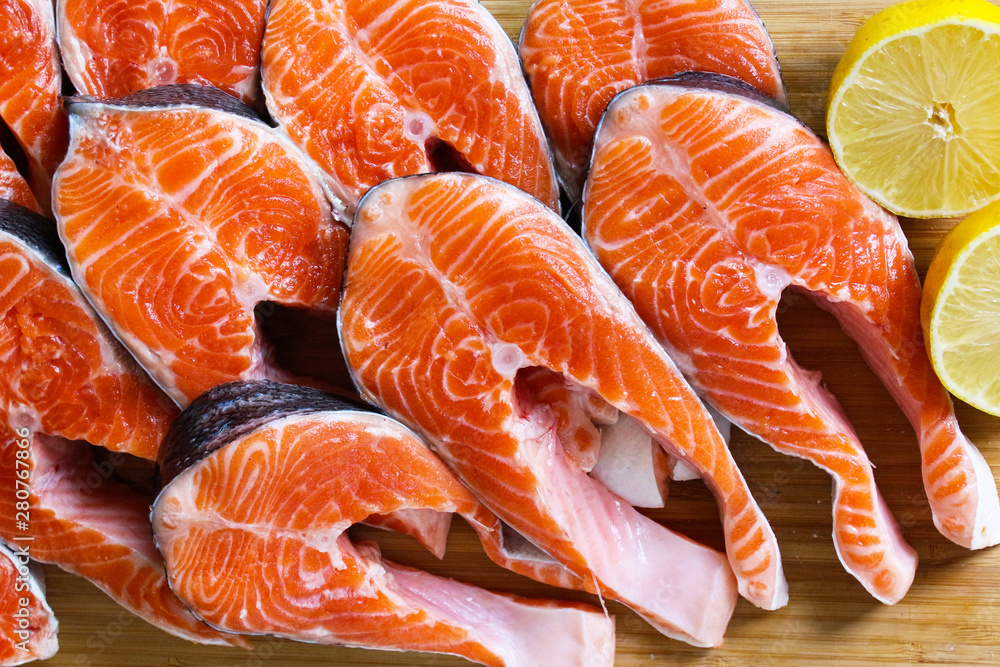 Red fish steak, freshly cut with peel on a cutting board Red fish steak, freshly cut with peel on a cutting board