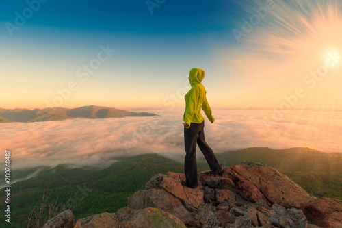 A woman on top mountain, summer cloudscape © erainbow