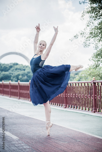 Young ballerina dancing in city streets  feeling breath of big city life and freedom 