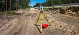 Panoramic view of surveyor equipment (theodolite or total positioning station) on the construction site of the motorway or road