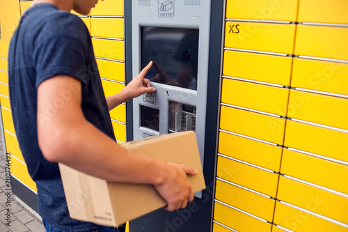 Client using automated self service post terminal machine or locker to deposit a parcel for storage