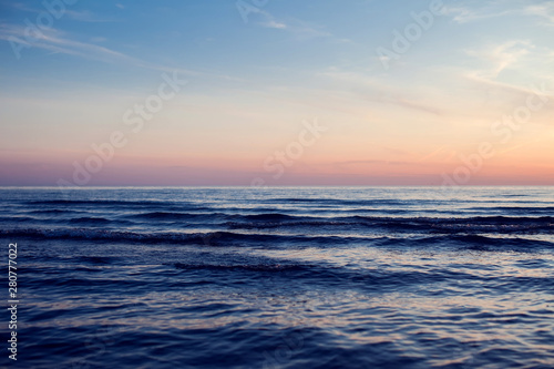 A sunset on the beach. Sea and eveninig sky with clouds