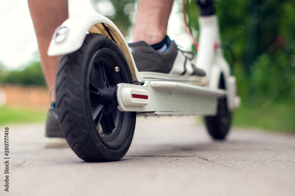 A man using electric scooter. Eco transport concept A man using electric scooter. Eco transport concept