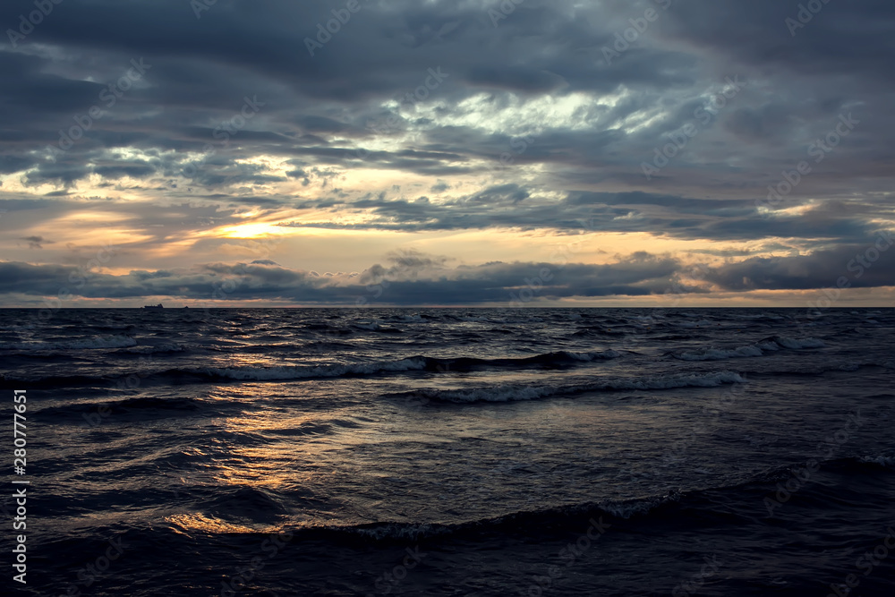 A sunset on the beach. Sea and eveninig sky with clouds