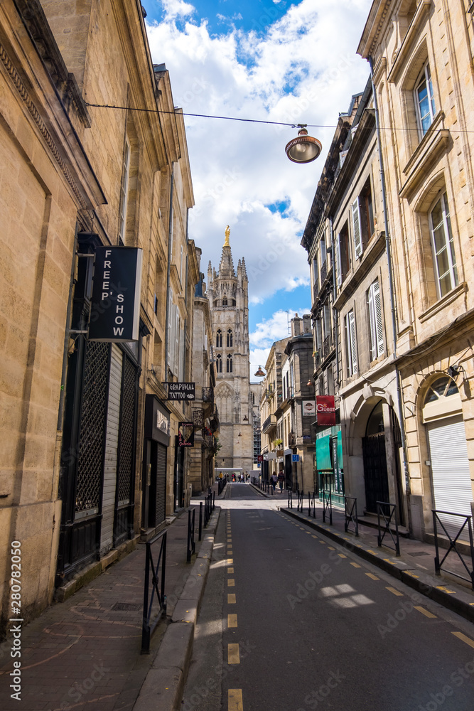 A narrow street with old residential buildings in the historical center of Bordeaux, France