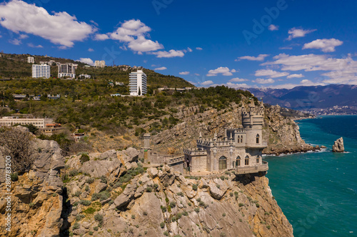 Fototapeta Naklejka Na Ścianę i Meble -  Castle Swallow's Nest on a rock at Black Sea, Crimea. Castle is located in the urban area of Gaspra, Yalta. Aerial drone view