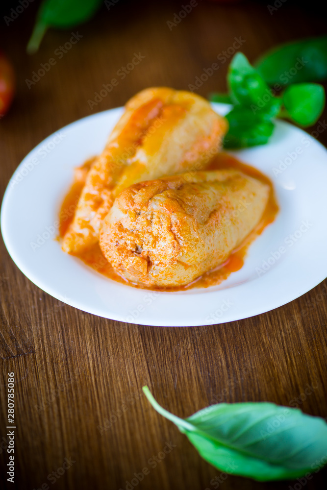 stuffed pepper with meat and vegetable sauce in a plate stuffed pepper with meat and vegetable sauce in a plate