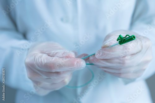 Urological catheter in the hands of a doctor. Close-up. photo
