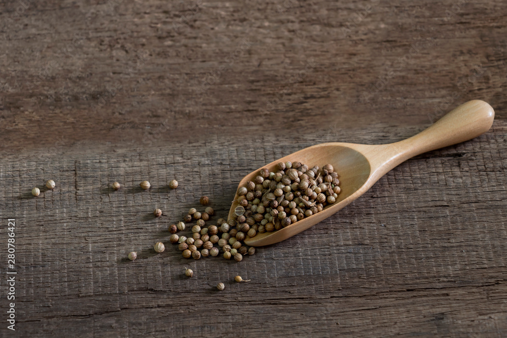 Spices dried coriander seed in spoon wood on old kitchen table. Food and cuisine ingredients. Spices dried coriander seed in spoon wood on old kitchen table. Food and cuisine ingredients.