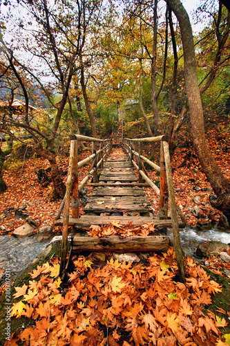 A wooden bridge at the entrance of the remote Athamania village, Aspropotamos region, Trikala Prefecture, Thessaly, Greece.  photo