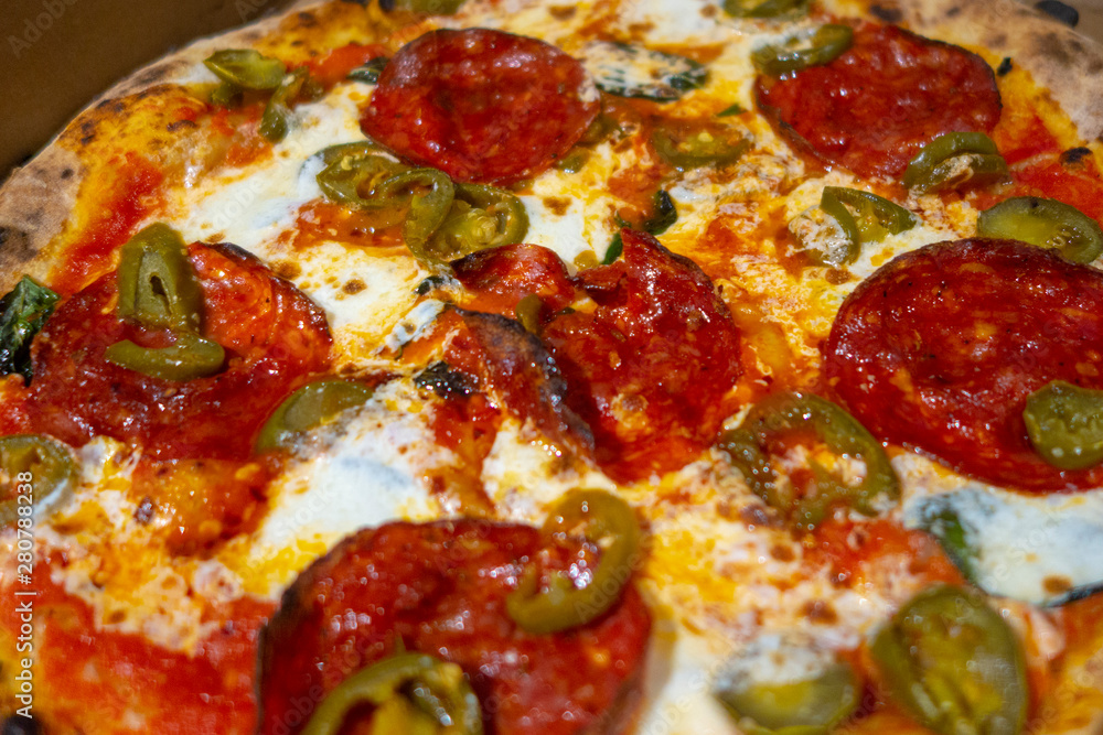 brick oven Neapolitan-style pizza with spicy Hot Soppressata, fresh mozzarella, fresh basil in a pizza box brick oven Neapolitan-style pizza with spicy Hot Soppressata, fresh mozzarella, fresh basil in a pizza box