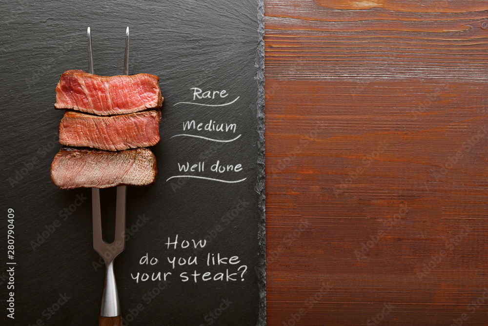 Three pieces of meat on a fork for meat. three types of meat roasting, rare, medium,well done.