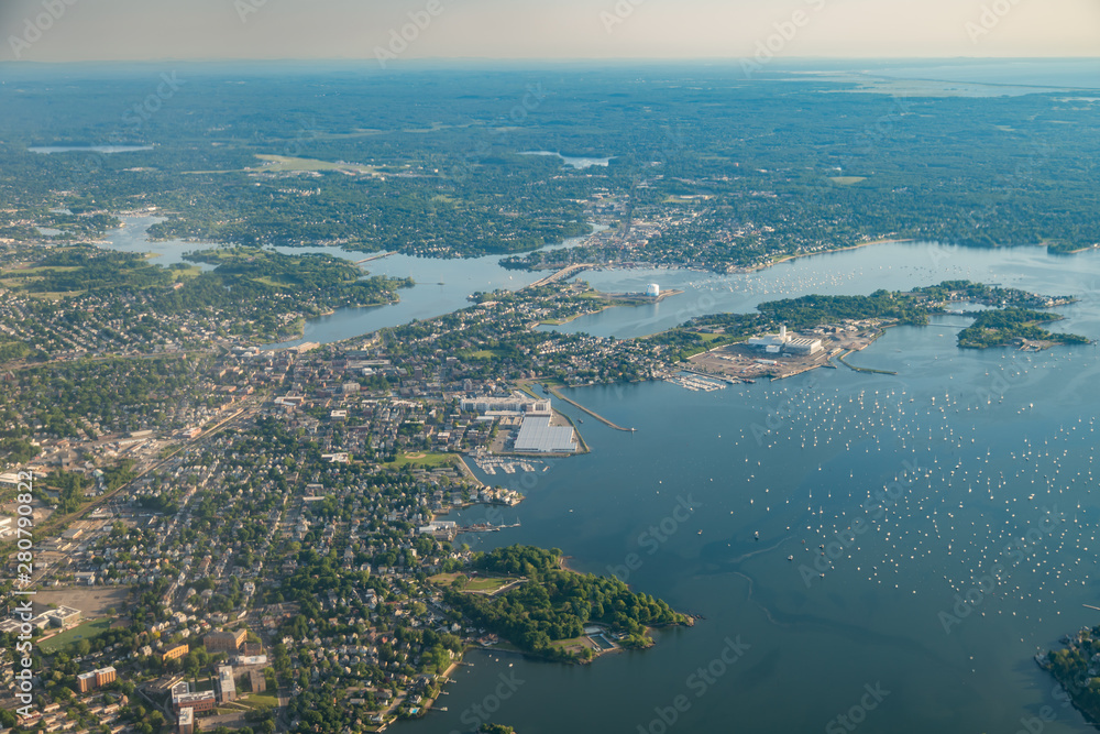 Fototapeta premium Aerial View of Small East Coast Town with Large Cove and Sailboats