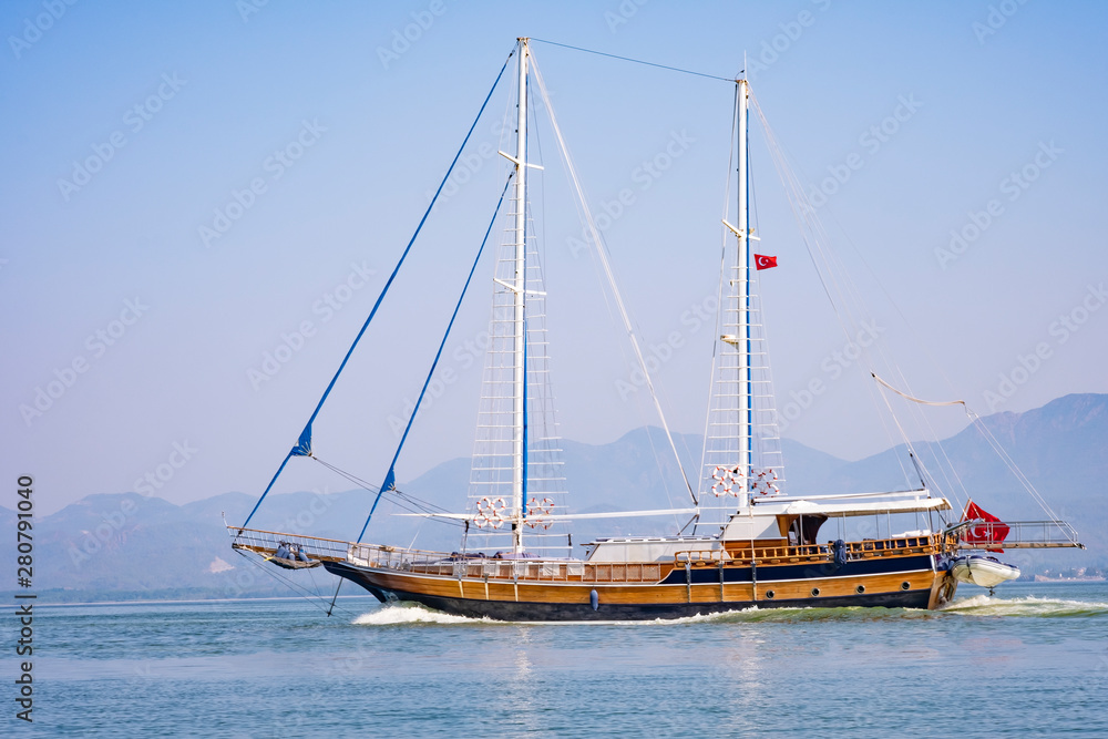 Sailboat in the sea in the morning light on the background of beautiful big mountains,Summer adventures, outdoor activities in the Mediterranean sea, Turkey