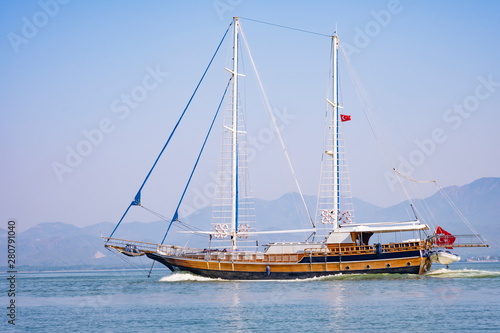 Sailboat in the sea in the morning light on the background of beautiful big mountains,Summer adventures, outdoor activities in the Mediterranean sea, Turkey