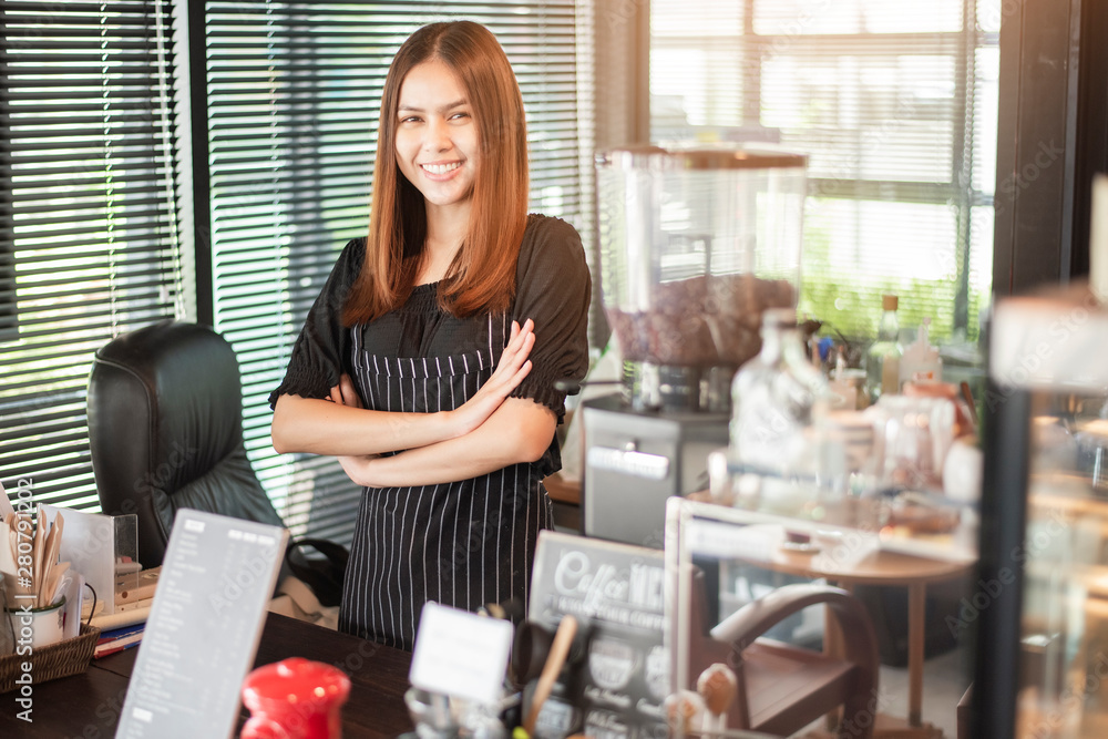 Beautiful barista is smiling in her coffee shop Beautiful barista is smiling in her coffee shop
