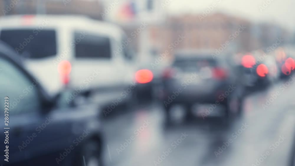Blured traffic jams background. Cars in traffic jam in rainy weather shot from behind. Slow motion. Blured traffic jams background. Cars in traffic jam in rainy weather shot from behind. Slow motion.