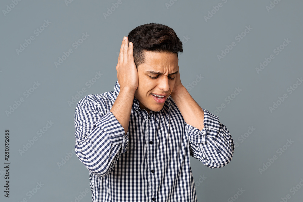 Desperate Man Covering His Ears With Hands On Gray Background Desperate Man Covering His Ears With Hands On Gray Background
