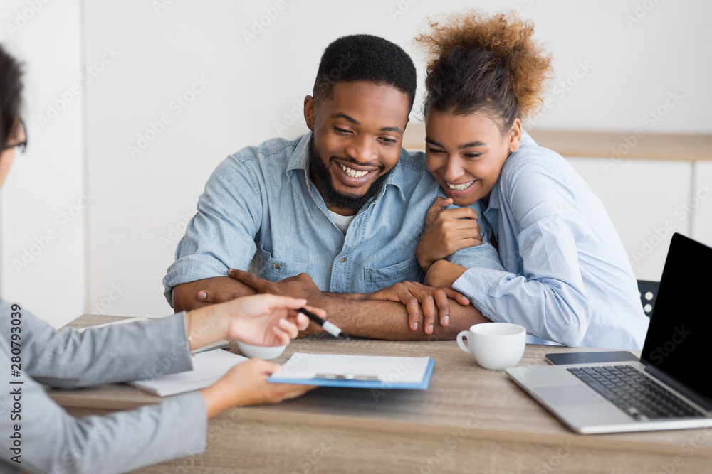 Joyful afro couple sitting at family counselor's office Joyful afro couple sitting at family counselor's office