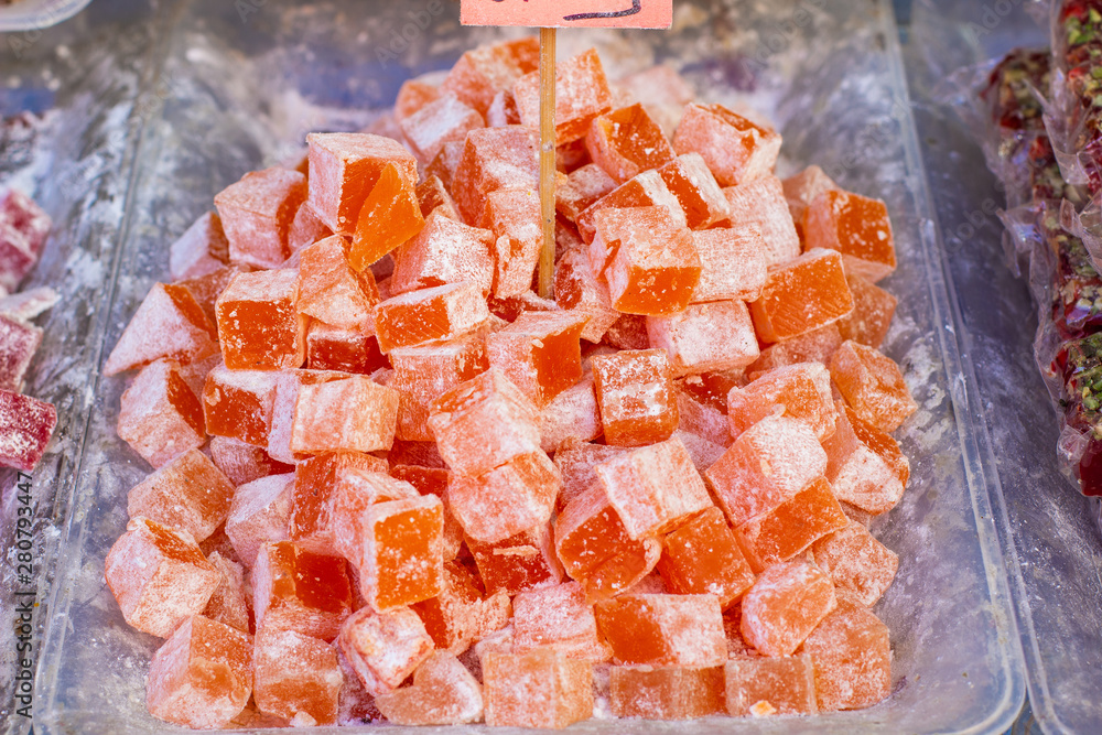orange marmalade unhealthy sweet candies with a lot of sugar in Eastern market counter background for selling orange marmalade unhealthy sweet candies with a lot of sugar in Eastern market counter background for selling