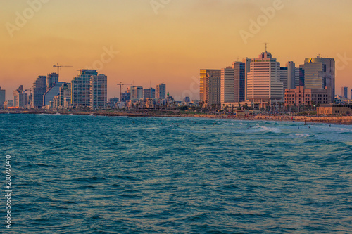beautiful Tel Aviv Israeli capital city with skyscrapers buildings on Mediterranean sea wavy waterfront landmark and landscape photography in colorful sunset evening time © Артём Князь