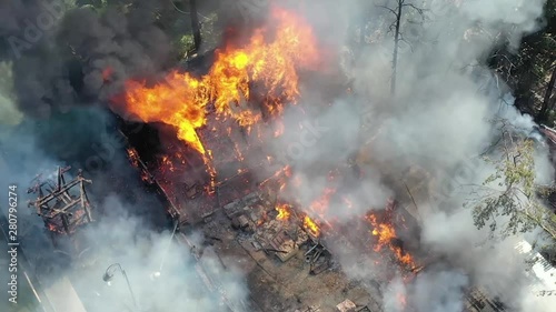 Wallpaper Mural Flames burn as brave firefighters work on a dangerous house and car on fire. 4K footage from drone Torontodigital.ca