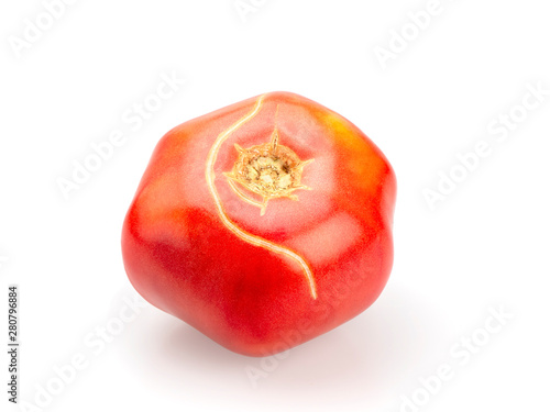 Ripe cracked tomato. On white background, isolated. Close-up. Still life.