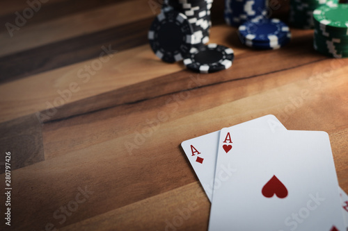 Poker Chips with Playing Cards on a Beautiful Wooden Table