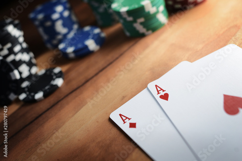 Poker Chips with Playing Cards on a Beautiful Wooden Table