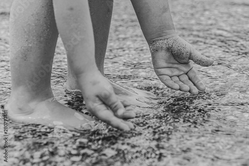 hands of a child in the black sea