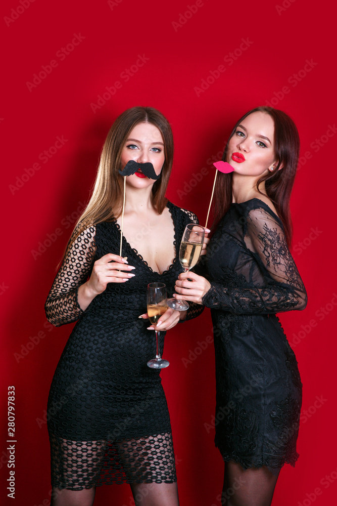 two beautiful stylish women in elegant casual black outfit celebrating new year, birthday , having fun two beautiful stylish women in elegant casual black outfit celebrating new year, birthday , having fun
