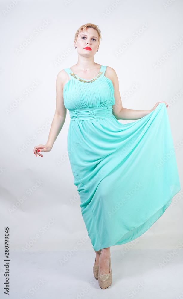 curvy plus size woman in long mint blue dress on white isolated studio background standing curvy plus size woman in long mint blue dress on white isolated studio background standing