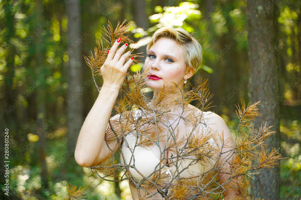 Φωτογραφία beautiful plus size girl in lingerie in the woods holding a fir branch